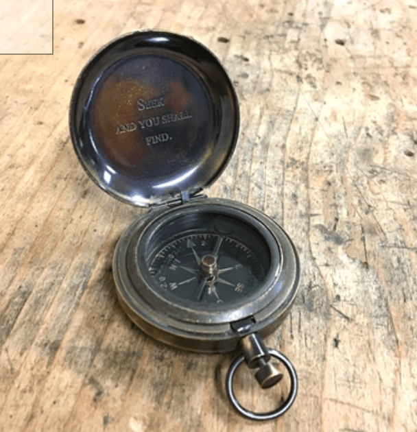 Seek and you shall find push button compass with leather pouch - Casey & Company